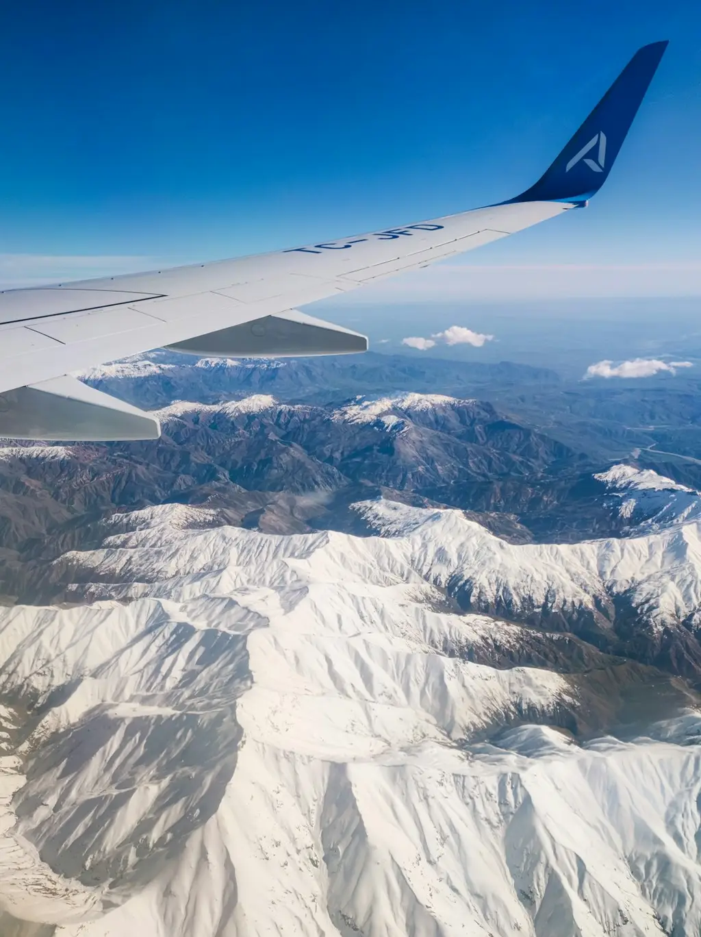 a view of a mountain range from an airplane