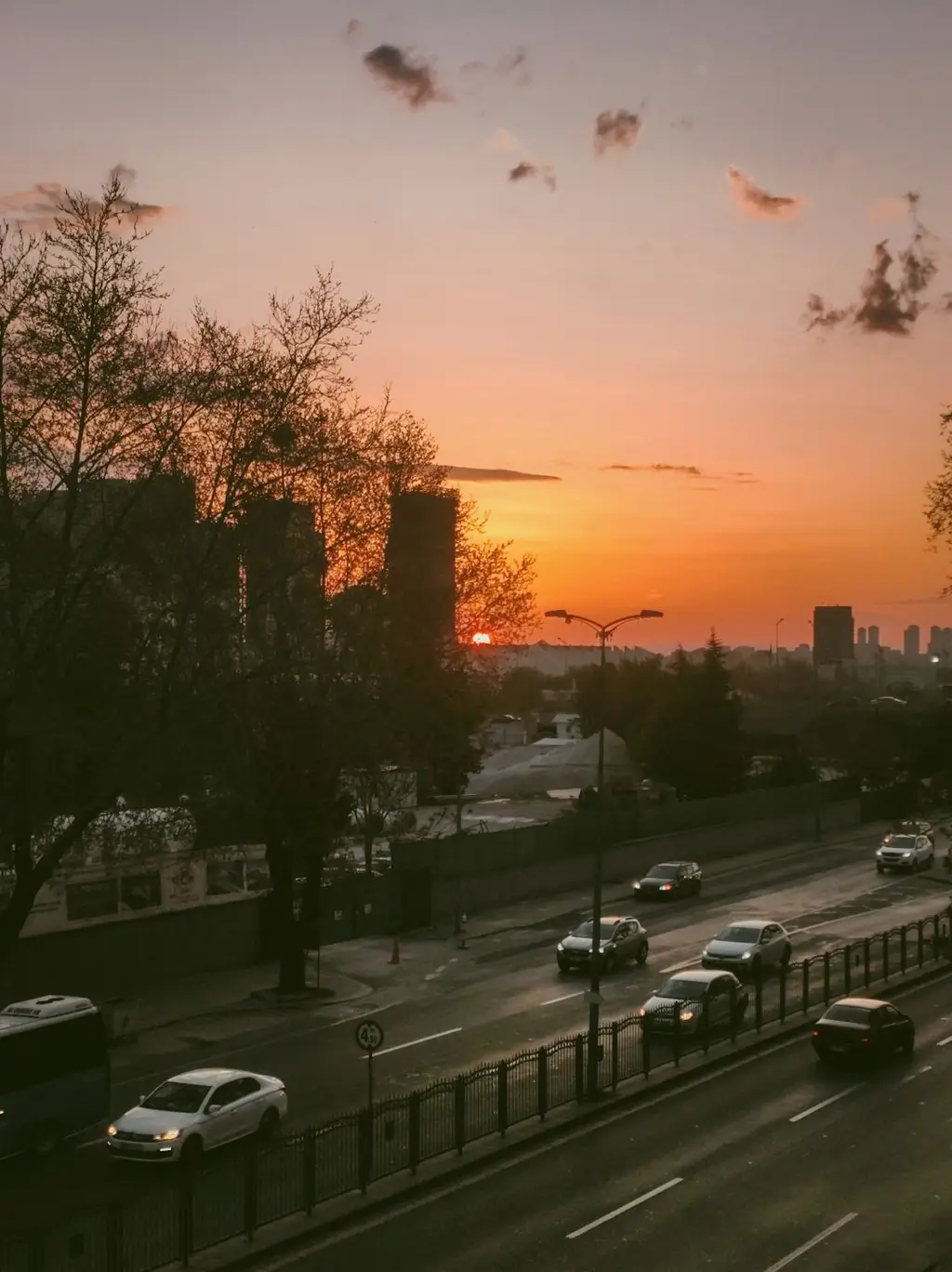 A sunset view of a city street with traffic